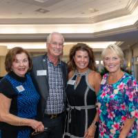 Pat Waring and Natalie Bernecker posing for photo with Chuck and Teri Losey
